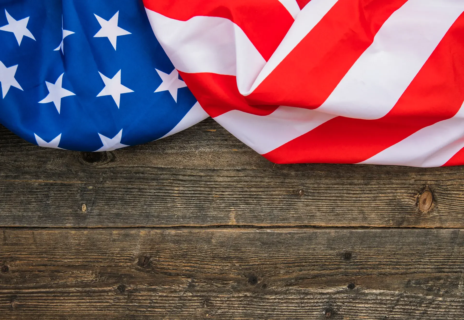 Close-up of an American flag draped over a wooden surface